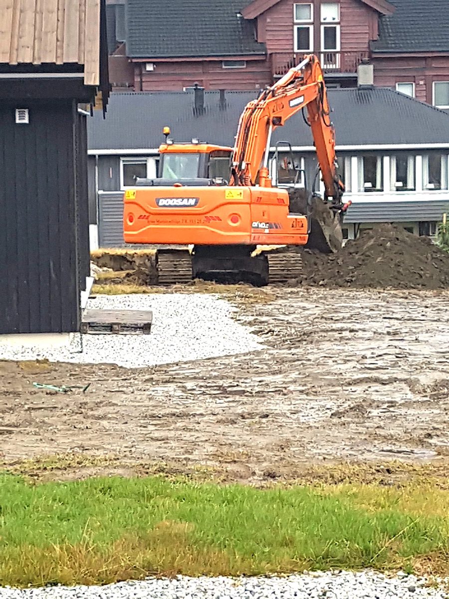 Gravemaskin på tomt ved bolig